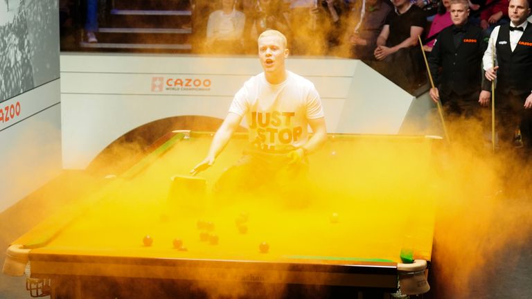 Cazoo World Snooker Championship 2023 - Day 3 - The Crucible
A Just Stop Oil protester jumps on the table during the match between Robert Milkins against Joe Perry during day three of the Cazoo World Snooker Championship at the Crucible Theatre, Sheffield. Picture date: Monday April 17, 2023.