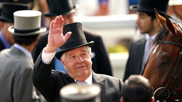 Sir Michael Stoute salutes someone in the crowd after winning a sixth Derby with Desert Crown