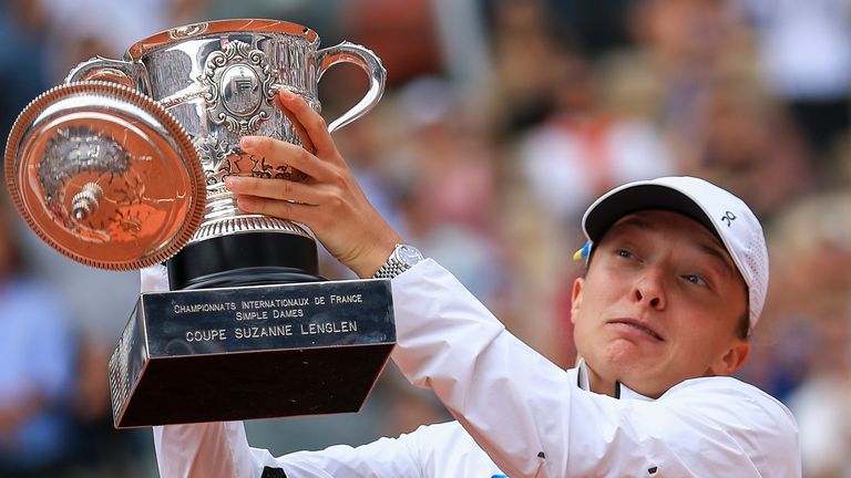 The lid flies off the trophy as Poland&#39;s Iga Swiatek celebrates winning the women&#39;s final match of the French Open tennis tournament against Karolina Muchova of the Czech Republic in three sets, 6-2, 5-7, 6-4, at the Roland Garros stadium in Paris, Saturday, June 10, 2023. (AP Photo/Aurelien Morissard)