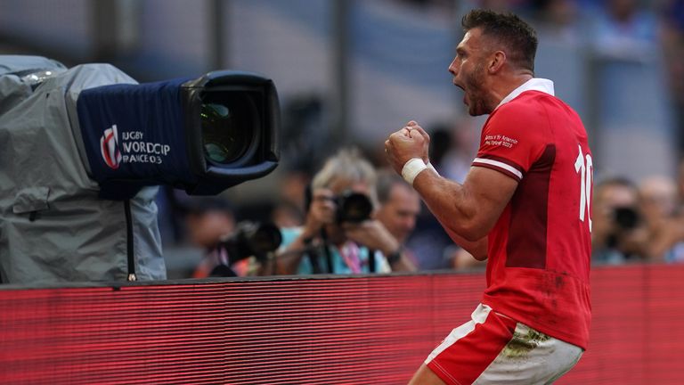 Dan Biggar celebrates after scoring the opening try for Wales