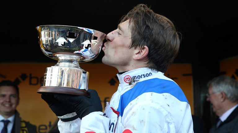 Harry Skelton kisses the Betfair Chase trophy after victory on Protektorat