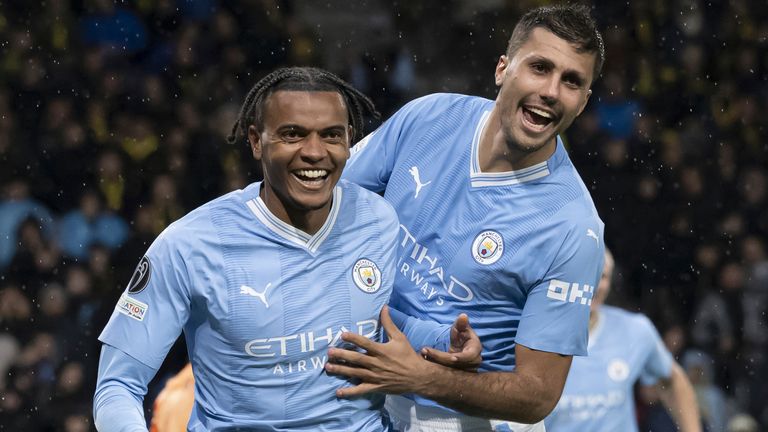 Manchester City&#39;s Manuel Akanji, left, celebrates scoring a goal with team-mate Rodri vs Young Boys