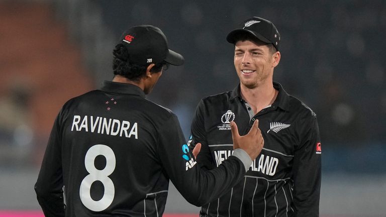 New Zealand&#39;s Mitch Santner celebrates with teammate Rachin Ravindra after finishing his bowling spell 