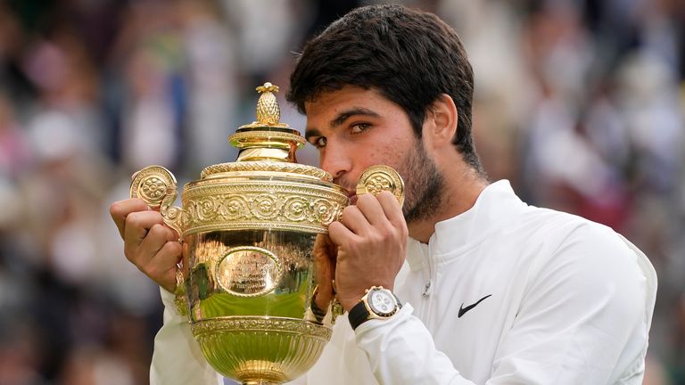 Spain's Carlos Alcaraz celebrates with the Wimbledon men's trophy 