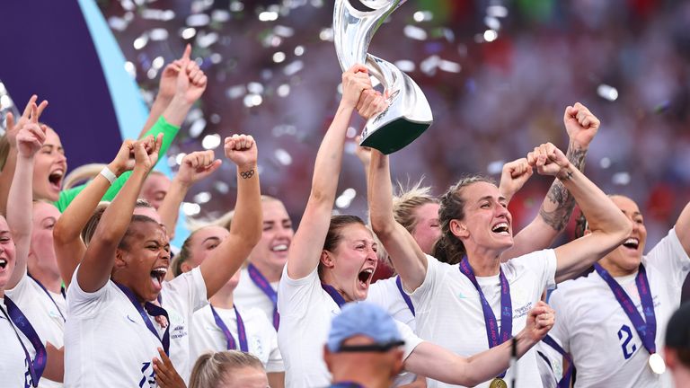 Jill Scott celebrates with the trophy at Wembley