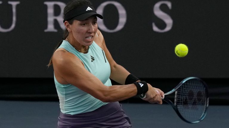 Jessica Pegula, of the United States, returns the ball during a women&#39;s singles final of the WTA Finals tennis championships against Iga Swiatek, of Poland, in Cancun, Mexico, Monday, Nov. 6, 2023. (AP Photo/Fernando Llano)