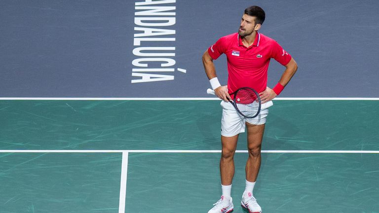 Serbia&#39;s Novak Djokovic reacts during his match with his teammate Miomir Kecmanovic against Italy&#39;s Jannik Sinner and Lorenzo Sonego during a Davis Cup semi-final doubles tennis match between Italy and Serbia in Malaga, Spain, Saturday, Nov. 25, 2023. (AP Photo/Manu Fernandez)