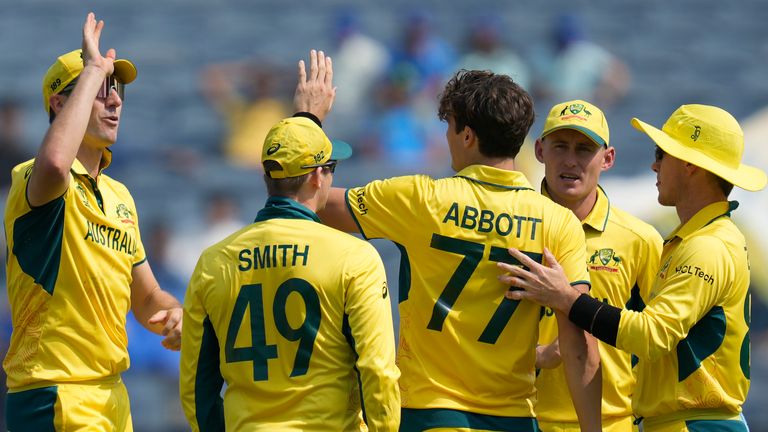 Australia&#39;s Sean Abbott celebrates the wicket of Bangladesh&#39;s Tanzid Hasan Tamim with teammates during the ICC Men&#39;s Cricket World Cup match between Australia and Bangladesh in Pune, India, Saturday, Nov. 11, 2023. (AP Photo/Rafiq Maqbool)