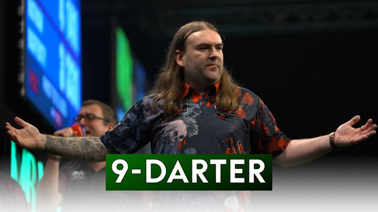 Ryan Searle hit a nine-darter to win his Group D match against Nathan Rafferty at the Grand Slam of Darts