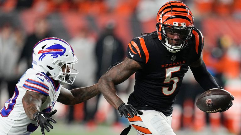 Wide receiver Tee Higgins runs with the ball as Buffalo Bills cornerback Dane Jackson tries to stop him.