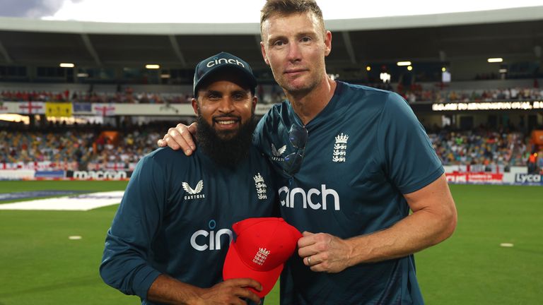 BRIDGETOWN, BARBADOS - DECEMBER 12: Adil Rashid of England is awarded his 100th T20 International cap by former England Cricketer Andrew Flintoff during the 1st T20 International between West Indies and England at Kensington Oval on December 12, 2023 in Bridgetown, Barbados. (Photo by Ashley Allen/Getty Images)