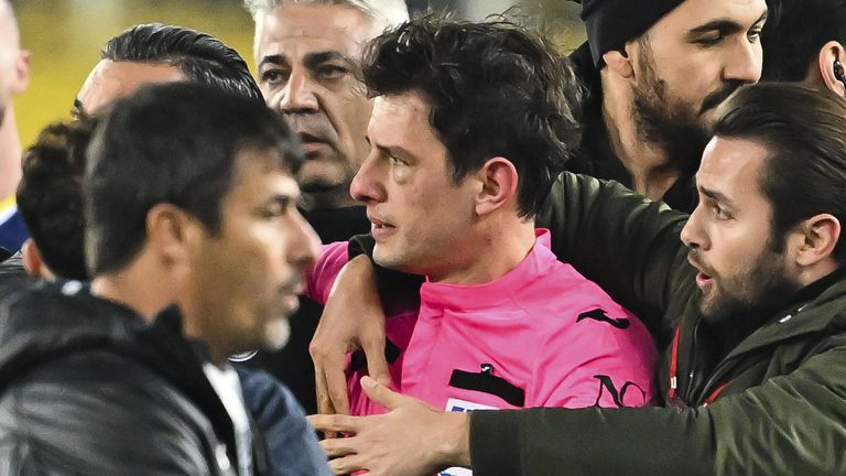 Referee Halil Umut Meler receives help after being punched by Ankaragucu president Faruk Koca