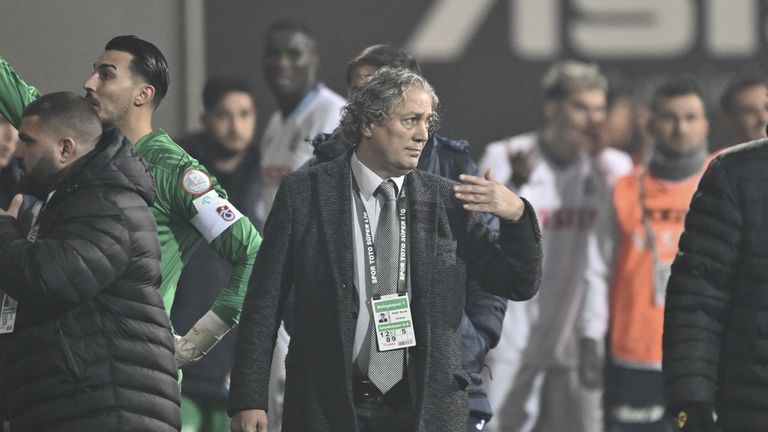 Istanbulspor president Faik Sarialioglu ushers his team off the pitch