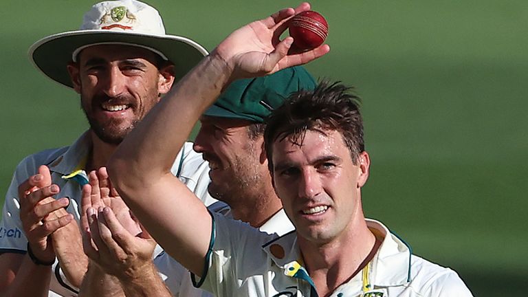 Australia&#39;s Pat Cummins, right, hold up the ball after taking 5 wickets against Pakistan during the fourth day of their cricket test match in Melbourne, Friday, Dec. 29, 2023. (AP Photo/Asanka Brendon Ratnayake)