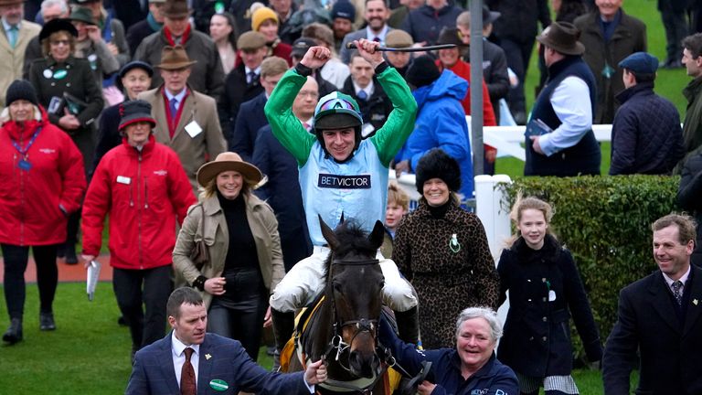 Gavin Sheehan holds his arms aloft in celebration after riding You Wear It Well to victory at Cheltenham