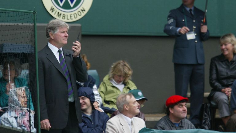 Wimbledon tennis referee Alan Mills (left) checks the weather before ordering ground staff to cover Centre Court today The covers were removed and put back several times between rain showers.