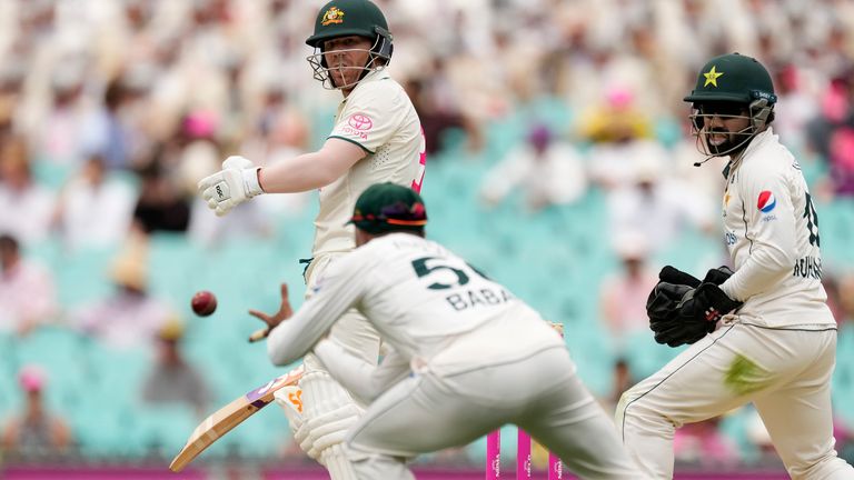 Australia&#39;s David Warner, left, turns to see his is caught out by Pakistan&#39;s Babar Azam on the second day of their cricket test match in Sydney, Thursday, Jan. 4, 2024. (AP Photo/Rick Rycroft)