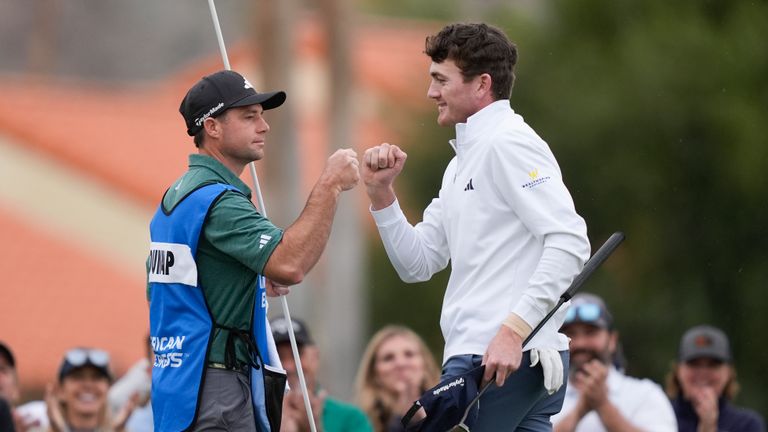 Nick Dunlap, right, bumps fists with his caddie on the ninth green at the La Quinta Country Club course during the third round of The American Express golf tournament Saturday, Jan. 20, 2024, in La Quinta, Calif. 