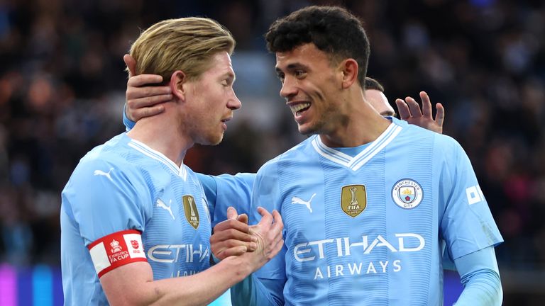 Kevin De Bruyne is congratulated by Matheus Nunes after setting up a goal for Jeremy Doku