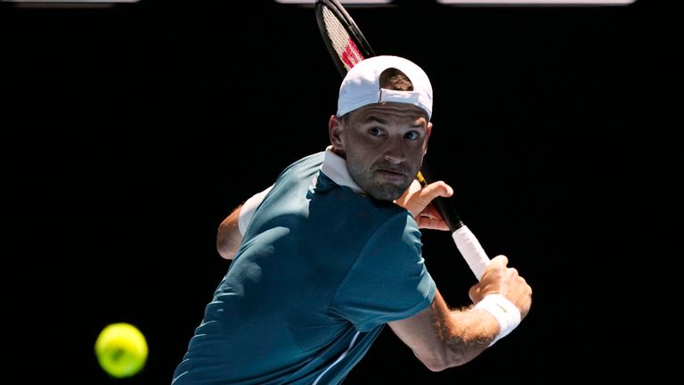 Grigor Dimitrov of Bulgaria plays a backhand return to Marton Fucsovics of Hungary during their first round match at the Australian Open tennis championships at Melbourne Park, Melbourne, Australia, Tuesday, Jan. 16, 2024. (AP Photo/Louise Delmotte)