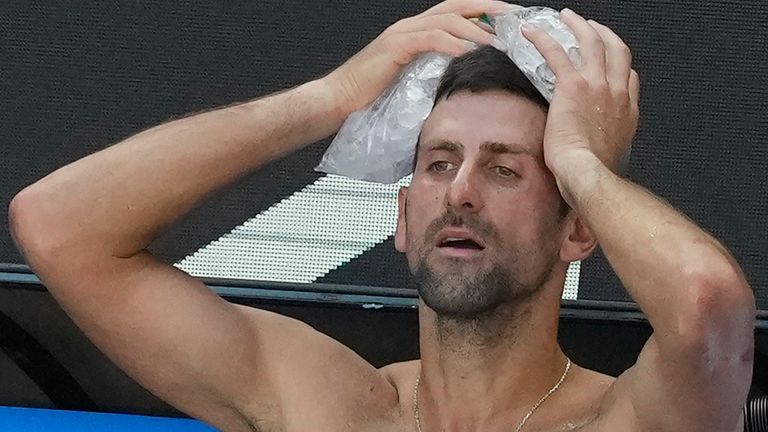 Novak Djokovic of Serbia places a bag of ice on his head during a break in his quarterfinal against Taylor Fritz of the U.S. at the Australian Open tennis championships at Melbourne Park, Melbourne, Australia, Tuesday, Jan. 23, 2024. (AP Photo/Alessandra Tarantino)