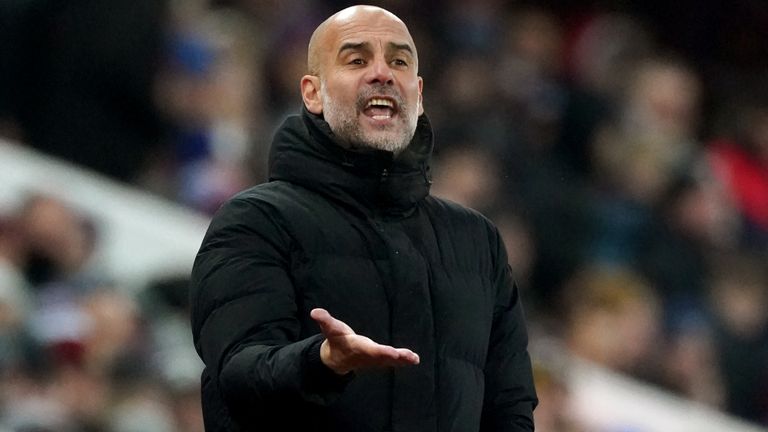 Pep Guardiola gestures on the touchline at Villa Park