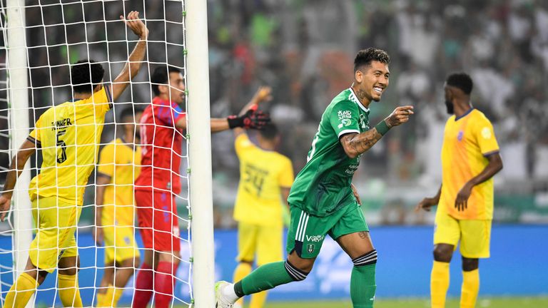 Al-Ahli player Roberto Firmino celebrates during his team match against Al-Hazm on the Saudi Pro League (SPL) at Prince Abdullah al-Faisal Stadium in Jeddah, Saudi Arabia, Friday, Aug. 11, 2023. (AP Photo/Jameel)