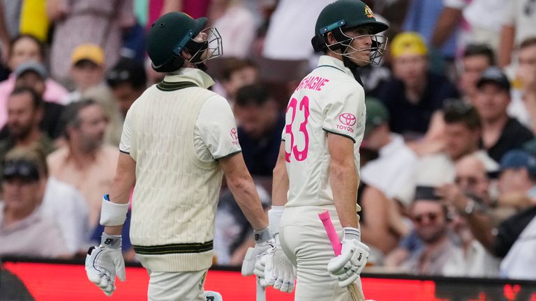 Australia&#39;s not out batters Steve Smith, left, and Marnus Labuschagne walk off the field after play against Pakistan is suspended due to poor light on the second day of their cricket test match in Sydney, Thursday, Jan. 4, 2024. (AP Photo/Rick Rycroft)