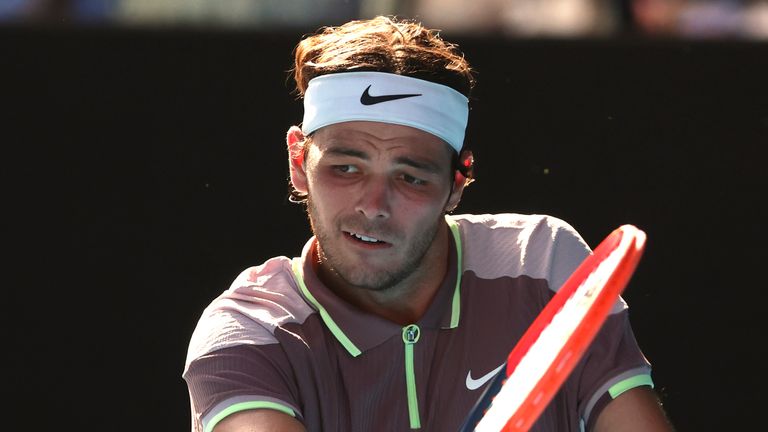 Taylor Fritz of the U.S. plays a backhand return to Novak Djokovic of Serbia during their quarterfinal match at the Australian Open tennis championships at Melbourne Park, Melbourne, Australia, Tuesday, Jan. 23, 2024. (AP Photo/Asanka Brendon Ratnayake)