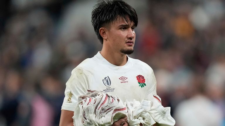 England's Marcus Smith holds t-shirts before to throw them to supporters at the end of the Rugby World Cup third place match between England and Argentina at the Stade de France in Saint-Denis, outside Paris, Friday, Oct. 27, 2023. (AP Photo/Pavel Golovkin)