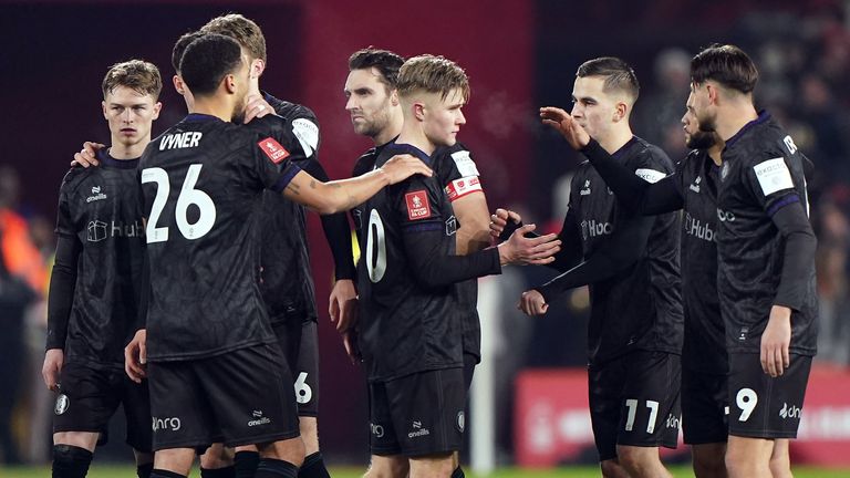 Sam Bell is consoled by his teammates after his penalty was saved in the shootout