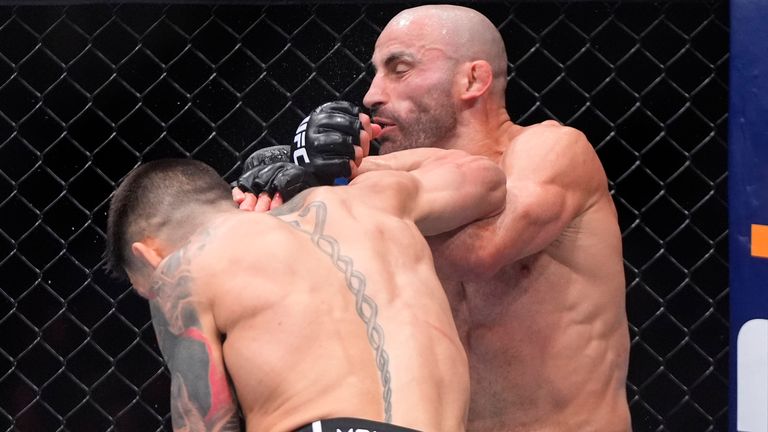 Ilia Topuria, left, delivers a knockout punch to Alexander Volanovski during their featherweight bout at the UFC 298 mixed martial arts event Saturday, Feb. 17, 2024, in Anaheim, Calif. (AP Photo/Mark J. Terrill)