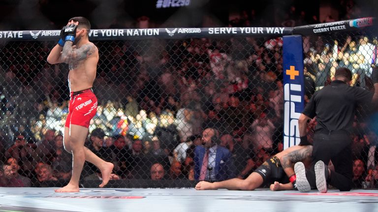 Ilia Topuria, left, celebrates after knocking out Alexander Volanovski during their featherweight bout at the UFC 298 mixed martial arts event Saturday, Feb. 17, 2024, in Anaheim, Calif. (AP Photo/Mark J. Terrill)