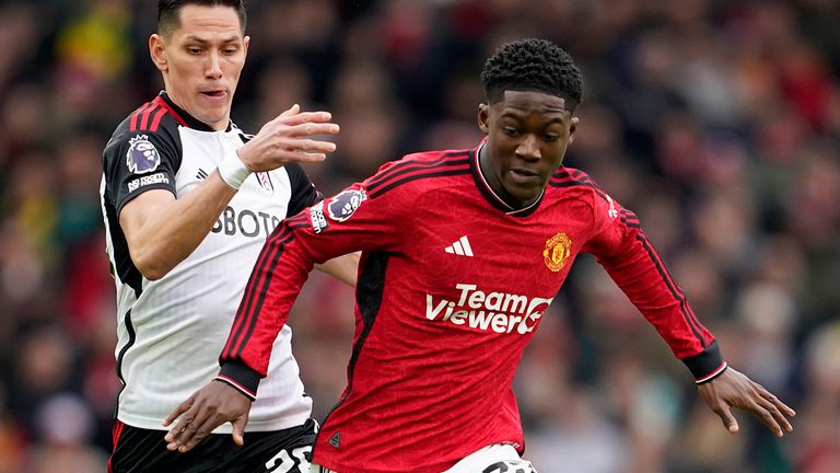 Fulham's Sasa Lukic and Manchester United's Kobbie Mainoo challenge for the ball