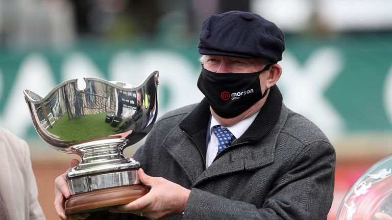 Clan Des Obeaux owner Sir Alex Ferguson collects the Betway Bowl trophy at Aintree