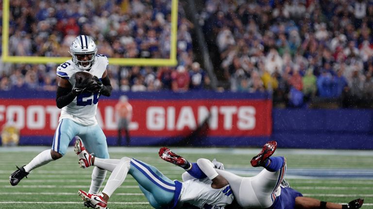 Dallas Cowboys&#39; DaRon Bland, left, intercepts a pass intended for New York Giants&#39; Saquon Barkley, right, during the first half of an NFL football game, Sunday, Sept. 10, 2023, in East Rutherford, N.J. (AP Photo/Adam Hunger)