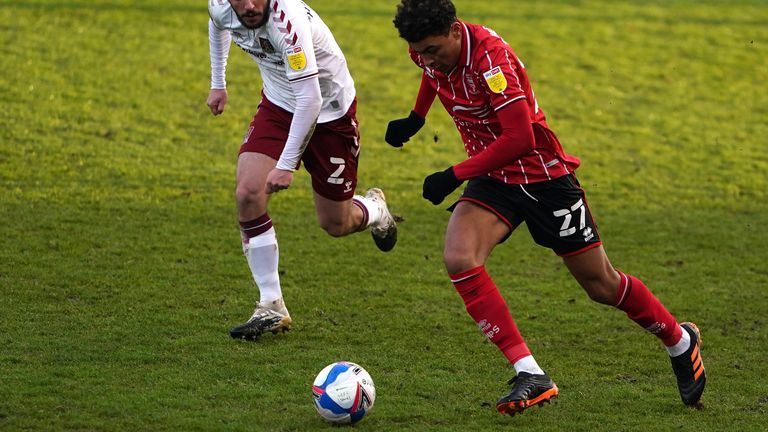 Lincoln City's Morgan Rogers (right) and Northampton Town's Michael Harriman battle for the ball during the Sky Bet League One match at LNER Stadium, Lincoln. Picture date: Saturday January 23, 2021.