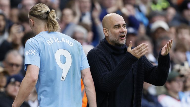 Erling Haaland speaks with Pep Guardiola after being substituted