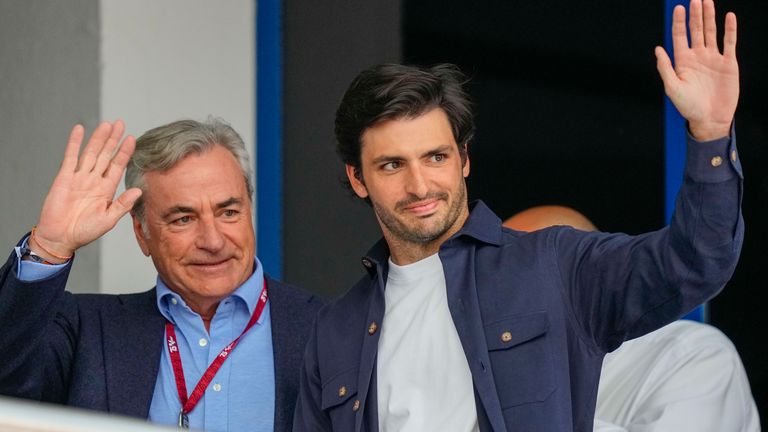 Ferrari driver Carlos Sainz of Spain, right, and his father Spanish rally driver Carlos Sainz Sr. wave after the MotoGP race of the Spanish Motorcycle Grand Prix at the Angel Nieto racetrack in Jerez de la Frontera, Spain, Sunday, April 28, 2024. (AP Photo/Jose Breton)