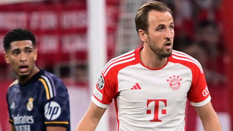 Bayern's Harry Kane, right, stands with Real Madrid's Jude Bellingham 