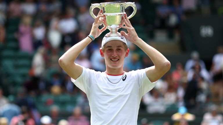 Henry Searle celebrates with the trophy after victory against Yaroslav following the Boys' Singles Final at the 2023 Wimbledon Championships