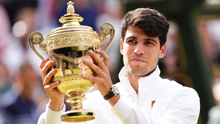 Carlos Alcaraz celebrates with the trophy after victory in the Gentlemen's Singles Final against against Novak Djokovic (not pictured) on day fourteen of the 2024 Wimbledon Championships at the All England Lawn Tennis and Croquet Club, London. Picture date: Sunday July 14, 2024.