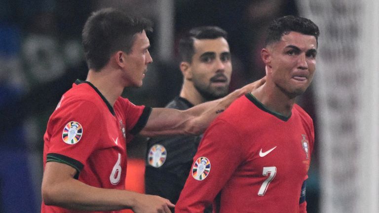 Portugal's forward #07 Cristiano Ronaldo (R) reacts to a missed penalty kick during the UEFA Euro 2024 round of 16 football match between Portugal and Slovenia at the Frankfurt Arena in Frankfurt am Main on July 1, 2024. (Photo by Kirill KUDRYAVTSEV / AFP)