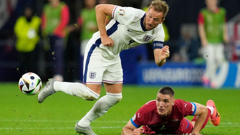 Harry Kane evades a challenge from Nikola Milenkovic