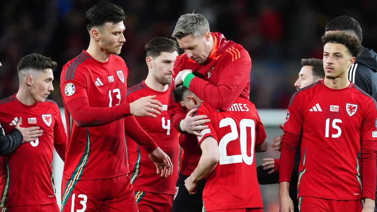 Dan James is consoled after missing a penalty to end Wales' hopes of qualifying for Euro 2024