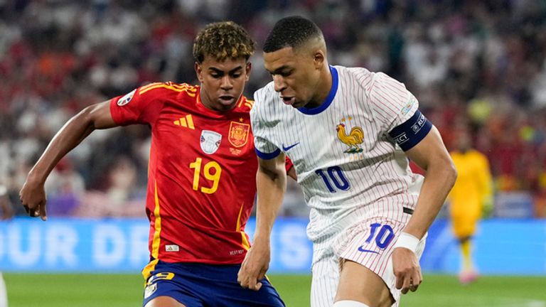 Spain's Lamine Yamal, left, and Kylian Mbappe of France compete for the ball during a semifinal match between Spain and France at the Euro 2024 soccer tournament in Munich, Germany, Tuesday, July 9, 2024. (AP Photo/Antonio Calanni)