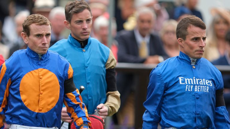 Jockeys wear black armbands in respect of John Hunt following the killing of the commentator's wife and two daughters. 