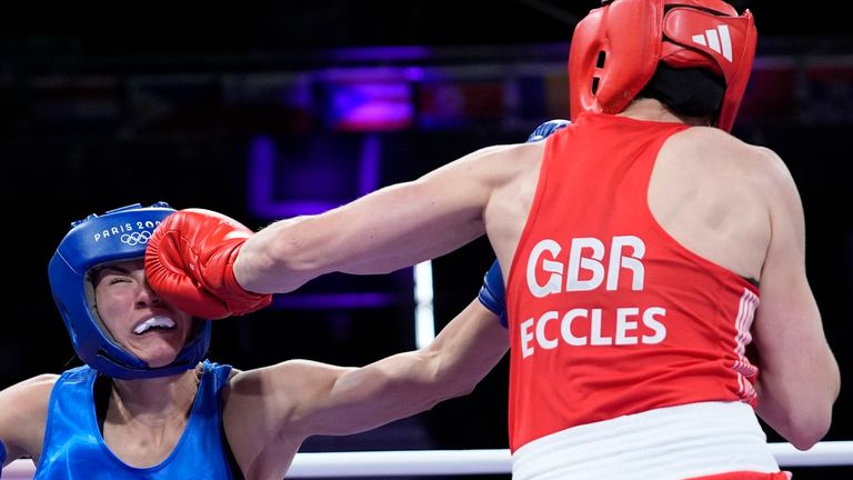 Britain's Rosie Eccles, right, punches Poland's Aneta Rygielska, during women's 66kg at the 2024 Summer Olympics, Sunday, July 28, 2024, in Paris, France. (AP Photo/John Locher)