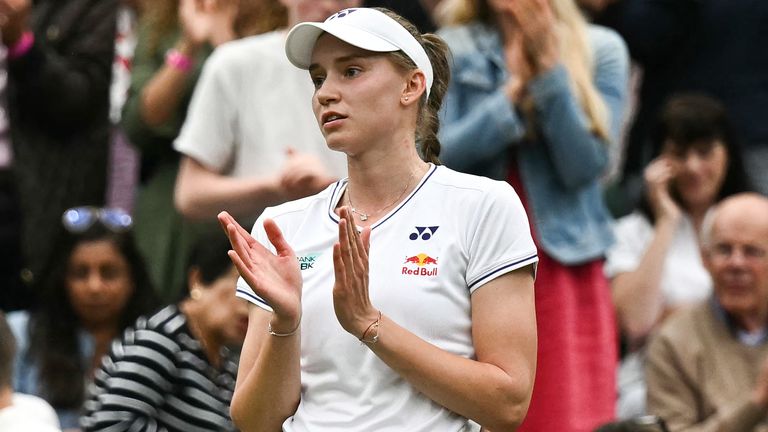 Kazakhstan's Elena Rybakina applauds Russia's Anna Kalinskaya leaving Centre Court after retiring from their women's singles tennis match on the eighth day of the 2024 Wimbledon Championships at The All England Lawn Tennis and Croquet Club in Wimbledon, southwest London, on July 8, 2024. (Photo by Ben Stansall / AFP) / RESTRICTED TO EDITORIAL USE