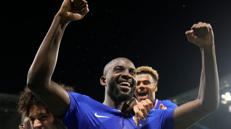 France's Jean-Philippe Mateta (14) celebrates with teammates after scoring his side's 2nd goal in extra time during the men's semifinal soccer match between France and Egypt, at Lyon Stadium, during the 2024 Summer Olympics, Monday, Aug. 5, 2024, in Decines, France. (AP Photo/Silvia Izquierdo)